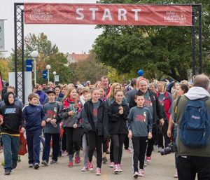 Some of the nearly 8,500 participants in the fourth annual Soles for Catholic Education Walk make their way through the Menomonee River Parkway, Saturday, Oct. 15. (Catholic Herald photo by Peter Fenelon)