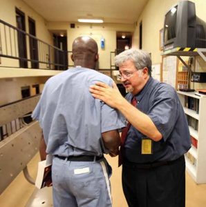 Catholic chaplain Dale Recinella talks to an inmate at Union Correctional Institution in Raiford, Fla., in this 2011 file photo. According to a new national survey, nearly three quarters of state prison chaplains are Protestant. Catholics make up 13 percent of prison chaplains, according to the study. (CNS photo/Daron Dean)