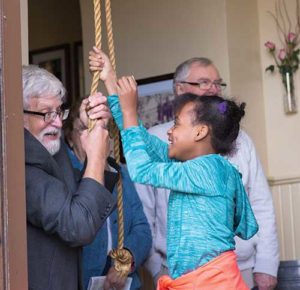Fr. Robert Stiefvater, former pastor of Our Lady of Guadalupe Parish, Milwaukee, helps Nadia Nwadbaraocha ring the church’s bell during the Archdiocese of Milwaukee’s first Very Important Parishes (VIP) tour, Saturday. Nov. 5. Fr. Stiefvater is pastor of All Saints, Milwaukee.