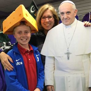 Sandra and Kip Murray pose with a cutout of Pope Francis at Cooney’s Sports Locker, Oconomowoc, during the run of the “Where’s the Pope?” contest, sponsored by St. Jerome Parish, Oconomowoc, earlier this year. The contest was an attempt at evangelization and a way to mark the Year of Mercy, according to parish organizers. (Submitted photo courtesy the Murray family)