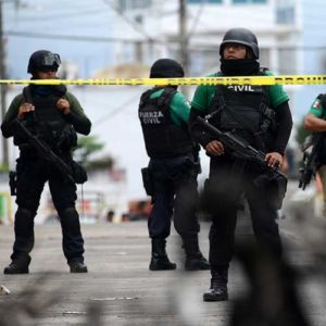 Police officers guard the municipal building in Catemaco, Mexico, Nov. 14 after it was set on fire following the disappearance of Fr. Jose Luis Sanchez Ruiz, pastor of Twelve Apostles parish. The outspoken priest, who had been reported missing in the state of Veracruz, was found alive, but with signs of torture. (CNS photo/Oscar Martinez, Reuters)