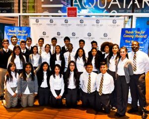 Cristo Rey students pose for a group photo at the Oct. 15 fundraiser at Discovery World, Milwaukee, where students and Cristo Rey business partners gathered to share stories about the partnership. (Catholic Herald photo by Juan C. Medina)