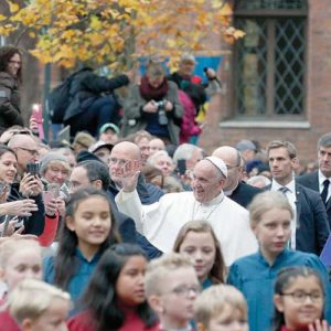Pope Francis greets the crowd as he walks with members of the Swedish royal family (not pictured) at the Kungshuset in Lund, Sweden, Oct. 31. The pope is making a two-day visit to Sweden to attend events marking the 500th anniversary of the Protestant Reformation. (CNS photo/Paul Haring)