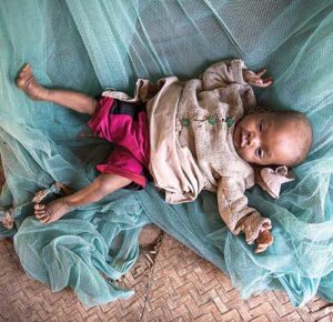 An eight-month-old baby lies on the floor at home in Amboasary, Madagascar, Sept. 21, 2015. Hunger levels are now so severe in drought-ridden southern Madagascar that many people in remote villages have eaten almost nothing but cactus fruit for up to four years, said a Catholic Relief Services official. (CNS photo/Shiraaz Mohamed, EPA)