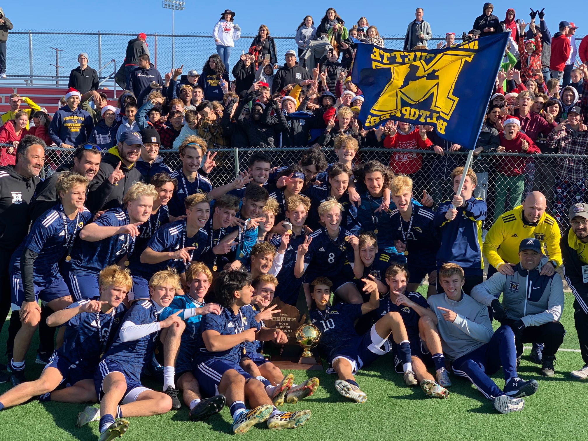 Marquette High School soccer team posing on field after winning 2021 state championship